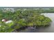 Aerial view showcasing the large lakefront lot with mature trees and access to a private dock at 2652 Lake Howell Ln, Winter Park, FL 32792