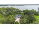 Aerial view showcasing the house, tree coverage, and its proximity to the lake at 2652 Lake Howell Ln, Winter Park, FL 32792