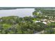 Expansive lakefront property featuring mature trees and several homes nestled on the shore at 2652 Lake Howell Ln, Winter Park, FL 32792