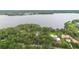 Lakefront property with mature trees and green lawns near other homes at 2652 Lake Howell Ln, Winter Park, FL 32792