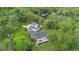 Aerial view of a spacious home featuring an outdoor deck overlooking a lush green yard at 2652 Lake Howell Ln, Winter Park, FL 32792