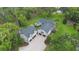Aerial view of home with dark roof and paved driveway at 2652 Lake Howell Ln, Winter Park, FL 32792