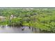 Beautiful lakefront estate with a red barn, surrounded by mature trees and landscaping at 2652 Lake Howell Ln, Winter Park, FL 32792