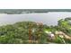 Lakefront property with private dock, lush landscaping, and property outline at 2652 Lake Howell Ln, Winter Park, FL 32792