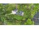A luxurious home surrounded by lush landscaping and a private lake pier, with a circular driveway at 2652 Lake Howell Ln, Winter Park, FL 32792