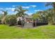 Large backyard with a deck, steps, and a lush lawn at 2652 Lake Howell Ln, Winter Park, FL 32792