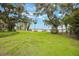 Lush backyard with mature trees, fireplace, and serene lake views offering ultimate relaxation at 2652 Lake Howell Ln, Winter Park, FL 32792