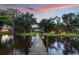 Scenic backyard view with wooden dock extending into lake at 2652 Lake Howell Ln, Winter Park, FL 32792