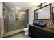 Modern bathroom with a glass-enclosed shower, stylish vanity, and tiled walls at 2652 Lake Howell Ln, Winter Park, FL 32792