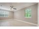 Spacious bedroom with large windows and neutral wall paint at 2652 Lake Howell Ln, Winter Park, FL 32792