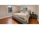 Cozy bedroom with hardwood floors, neutral walls, and a comfortable gray bed with side tables at 2652 Lake Howell Ln, Winter Park, FL 32792