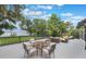 Stunning deck overlooking the lake, surrounded by lush trees and comfortable furniture at 2652 Lake Howell Ln, Winter Park, FL 32792