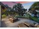 Outdoor deck with lounge furniture, string lights, and scenic waterfront view at 2652 Lake Howell Ln, Winter Park, FL 32792