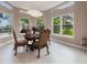Bright dining area with elegant decor, large windows, and views of the surrounding landscape at 2652 Lake Howell Ln, Winter Park, FL 32792