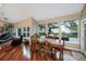 Bright dining room with lake views, hardwood floors, and access to an outdoor seating area at 2652 Lake Howell Ln, Winter Park, FL 32792