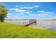 Scenic view of the lake with a wooden dock extending into the water and a covered area at 2652 Lake Howell Ln, Winter Park, FL 32792