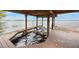 View from the covered dock area, showing a boat lift and lake at 2652 Lake Howell Ln, Winter Park, FL 32792