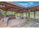 Covered boat house with wooden flooring and surrounding water views at 2652 Lake Howell Ln, Winter Park, FL 32792