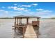 Close-up of a wooden dock with a covered area, offering lake access and scenic views at 2652 Lake Howell Ln, Winter Park, FL 32792