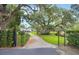 Long brick paved driveway framed by mature trees leads to the property at 2652 Lake Howell Ln, Winter Park, FL 32792