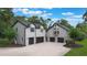 The house's exterior shows the garages and upper floors of the main house and guest house at 2652 Lake Howell Ln, Winter Park, FL 32792