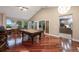 Spacious game room with pool table, hardwood floors, lake views, and access to dining room and kitchen at 2652 Lake Howell Ln, Winter Park, FL 32792