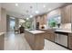Bright, modern kitchen with stainless appliances, white countertop island, and views of the dining area at 2652 Lake Howell Ln, Winter Park, FL 32792