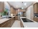 Well-appointed kitchen with stainless steel appliances, central island, and seamless access to the dining area at 2652 Lake Howell Ln, Winter Park, FL 32792