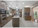 Modern kitchen equipped with stainless steel appliances, a center island, and sleek countertops at 2652 Lake Howell Ln, Winter Park, FL 32792