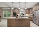 Modern kitchen equipped with stainless steel appliances, a center island, and stylish pendant lighting at 2652 Lake Howell Ln, Winter Park, FL 32792