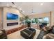 Bright living room with modern fireplace, hardwood floors, and large windows overlooking the lake at 2652 Lake Howell Ln, Winter Park, FL 32792