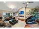 Inviting living room features a fireplace, large-screen TV, comfortable seating, and a massage chair at 2652 Lake Howell Ln, Winter Park, FL 32792