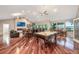 Spacious living room features a billiard table, bar, and lake views with hardwood floors and recessed lighting at 2652 Lake Howell Ln, Winter Park, FL 32792