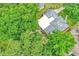 Aerial view of a house with lush landscaping, mature trees, and a well-manicured yard at 2910 Hargill Dr, Orlando, FL 32806
