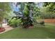 Lush tropical backyard featuring grass and landscaping at 2910 Hargill Dr, Orlando, FL 32806
