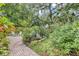 Picturesque backyard featuring lush greenery, brick pavers, and a fountain at 2910 Hargill Dr, Orlando, FL 32806
