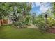 Lush backyard featuring thriving landscaping, pavers, stone path, and green lawn at 2910 Hargill Dr, Orlando, FL 32806