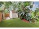 Spacious backyard featuring an outdoor storage shed, lush landscaping, and well-maintained lawn at 2910 Hargill Dr, Orlando, FL 32806