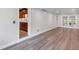 Finished basement shows luxury vinyl plank flooring, a kitchen area, and glass paneled doors to the outside at 2910 Hargill Dr, Orlando, FL 32806