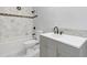 Bathroom features marble wall tiles, mosaic border tile, and a gray vanity at 2910 Hargill Dr, Orlando, FL 32806