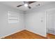 Simple bedroom with hardwood floors, light walls, and a built-in shelving, creating a clean and airy space at 2910 Hargill Dr, Orlando, FL 32806