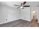 Bedroom features luxury vinyl plank flooring, a ceiling fan, and an entrance to the bathroom at 2910 Hargill Dr, Orlando, FL 32806