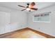 Cozy bedroom with light walls, hardwood floors, ceiling fan and a window offering natural light at 2910 Hargill Dr, Orlando, FL 32806