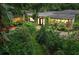Charming home exterior with lush landscaping, brick pathway, and inviting curb appeal at twilight at 2910 Hargill Dr, Orlando, FL 32806