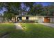 Inviting home with well-manicured lawn, illuminated pathway, and charming curb appeal at dusk at 2910 Hargill Dr, Orlando, FL 32806