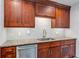 Modern kitchen featuring granite countertops, stainless steel appliances, and dark wood cabinetry at 2910 Hargill Dr, Orlando, FL 32806