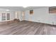 Spacious living room featuring wood floors, white walls, and doors to the outside at 2910 Hargill Dr, Orlando, FL 32806