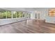 Bright living room featuring wood floors, large windows, and double french doors leading to the outside at 2910 Hargill Dr, Orlando, FL 32806