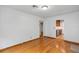Spacious living room featuring hardwood floors, white walls, and an open view to the kitchen at 2910 Hargill Dr, Orlando, FL 32806