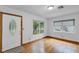 Bright living room with hardwood floors, a front door, and a large window with a view of the trees at 2910 Hargill Dr, Orlando, FL 32806